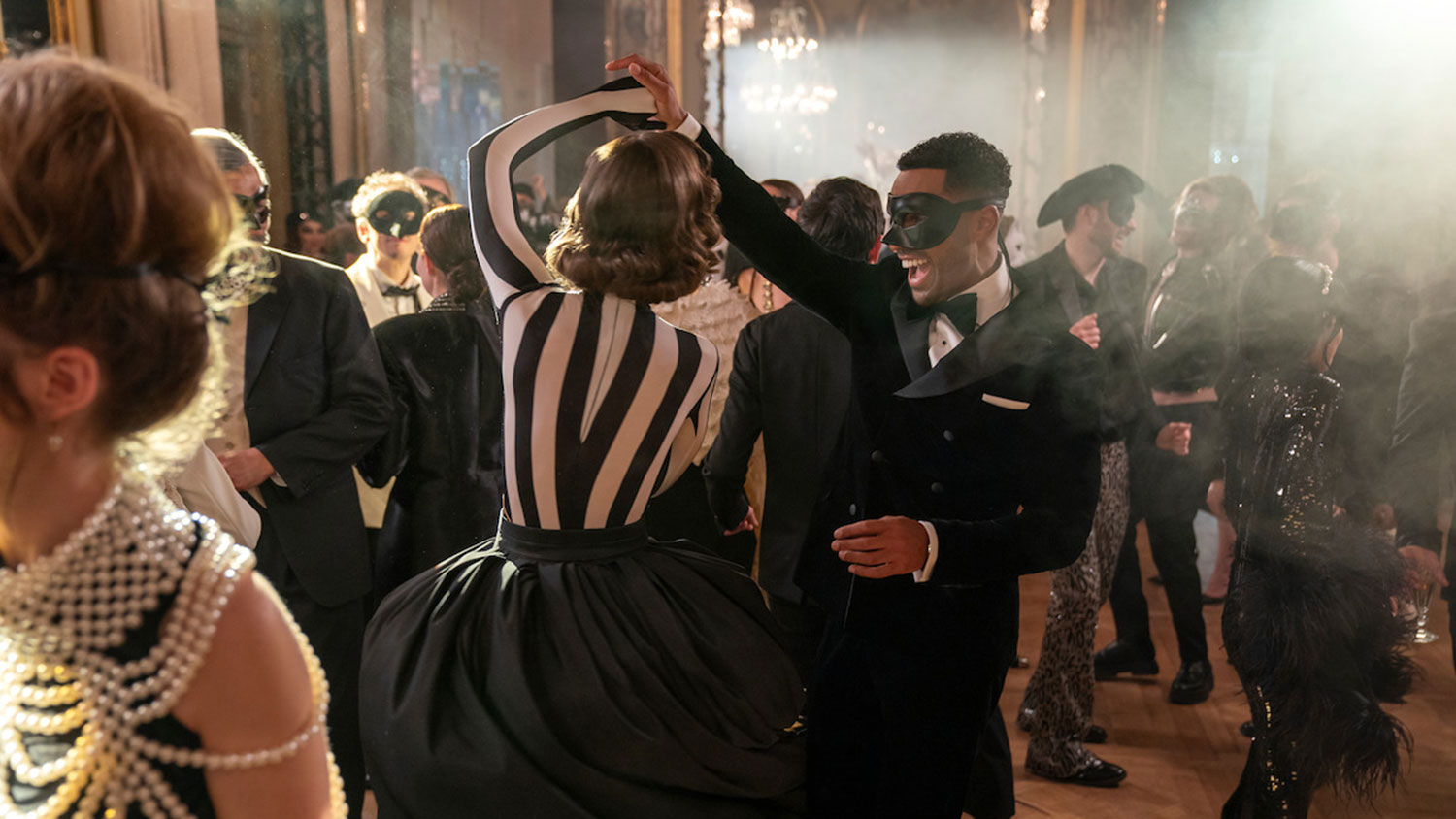 Emily and Alfie enjoying a dance during the masquerade party. (Photo: Tudum by Netflix)