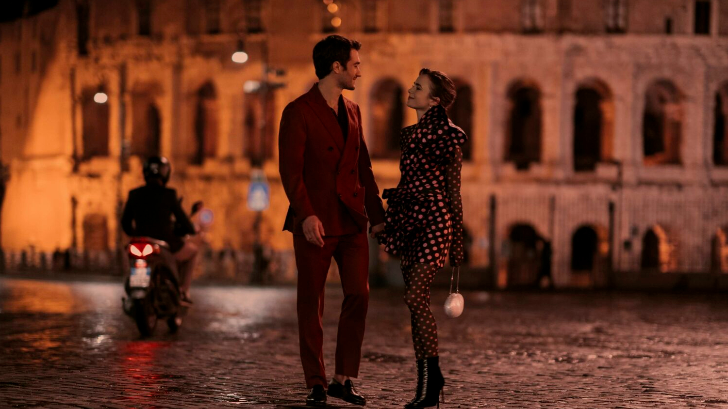 Emily and Marcello taking a walk in front of the Colosseum in Rome. (Photo: Giulia Parmigiani for Netflix)