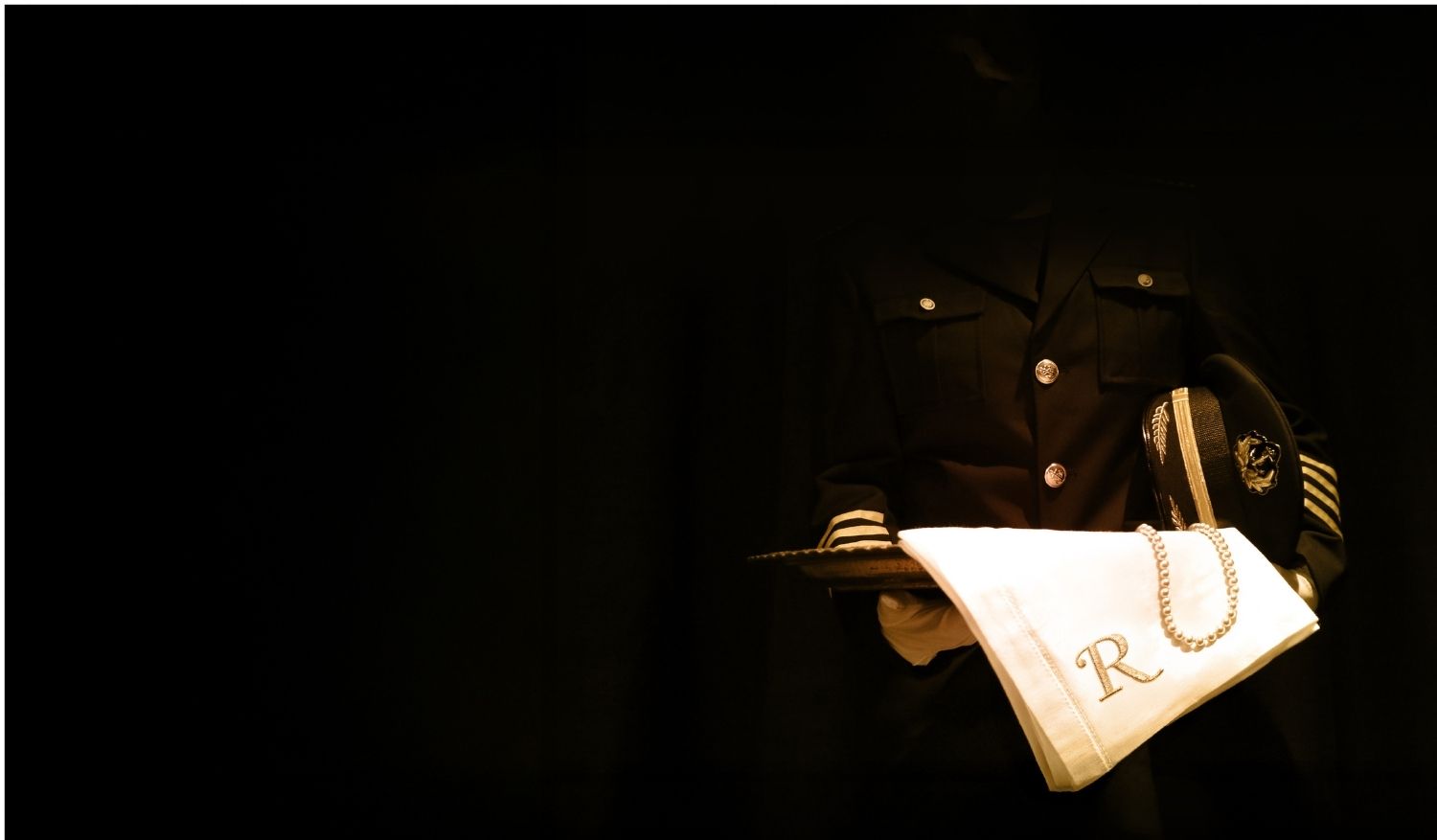 The lights go out. The A voice breaks the darkness as gourmet meals are served aboard the Titanic.