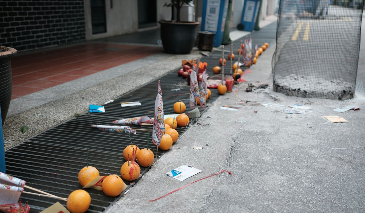 A line of offerings in front of shop lots in Singapore. (Credit: Galen Crout)