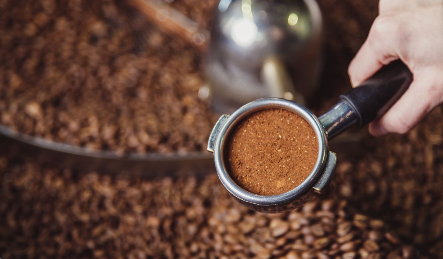 Portafilter with ground coffee, part of the production processes.